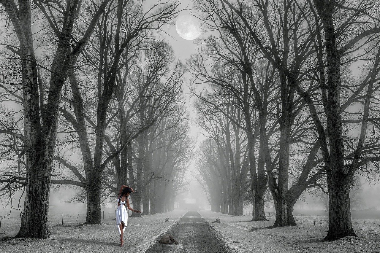Woman dancing in the snow under the moon