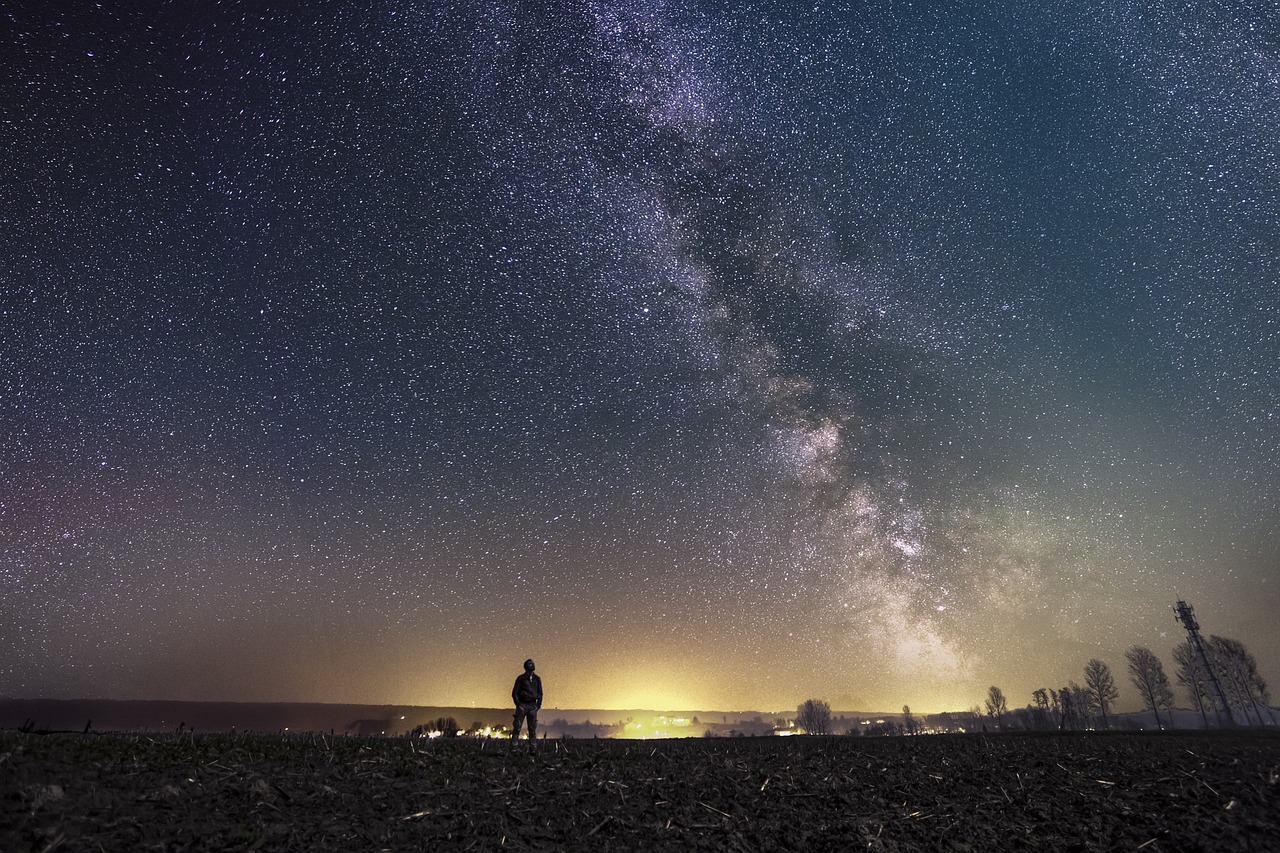 Person standing under a starry sky