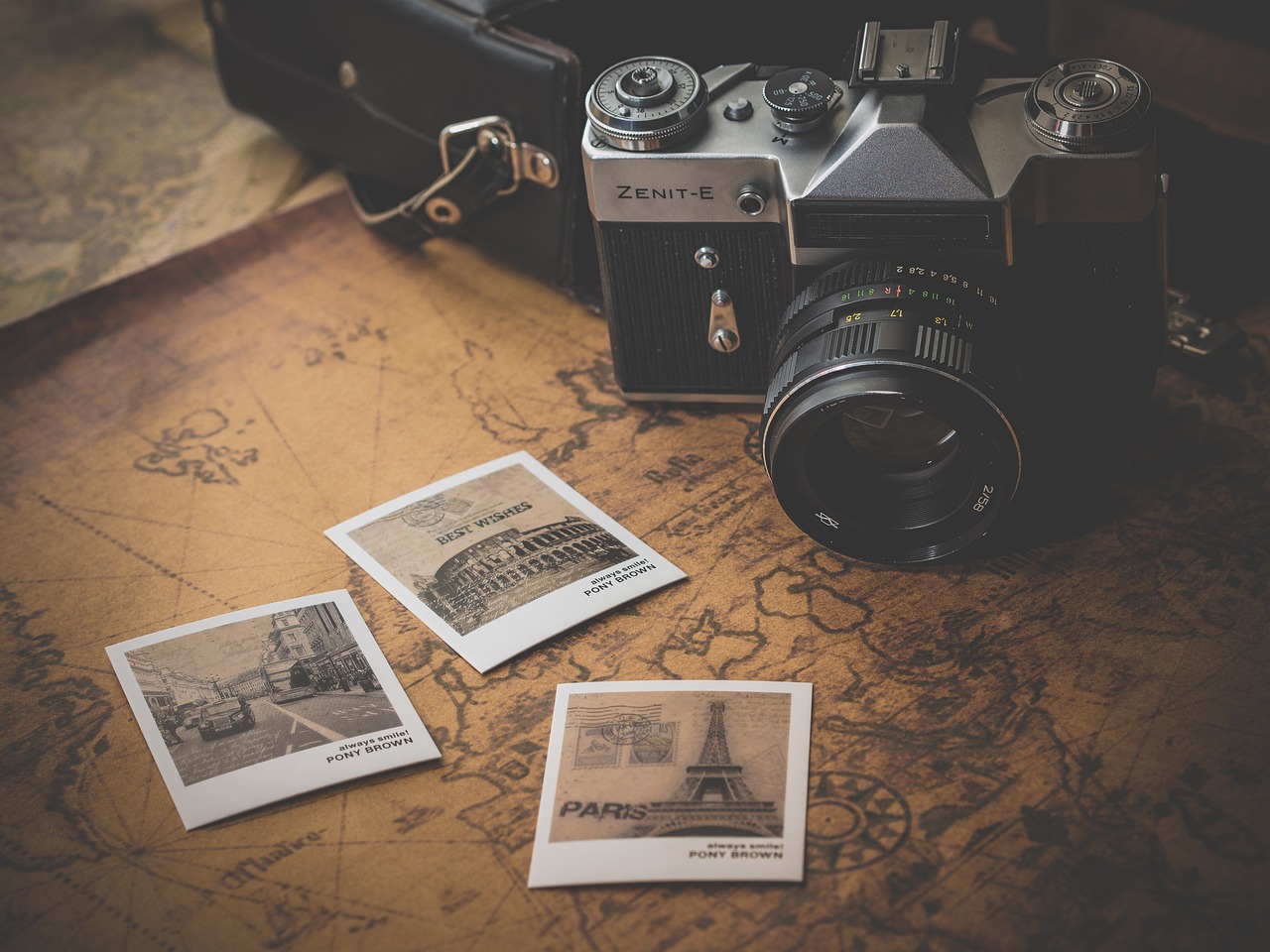 Vintage camera and map with travel photos