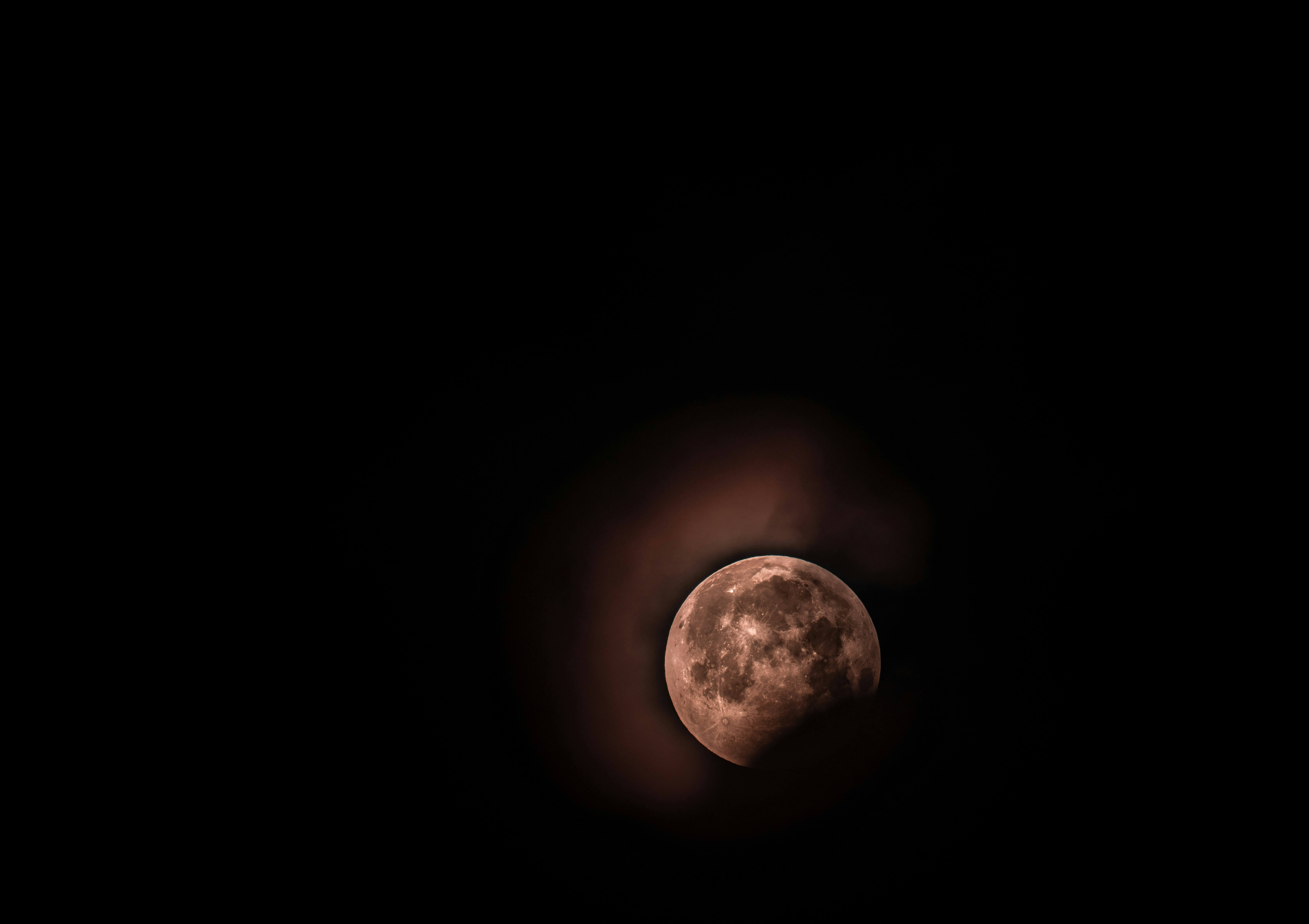 Partial solar eclipse with bright orange crescent shape