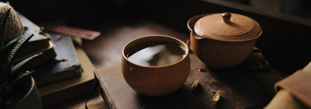 Herbal tea in cup and pot