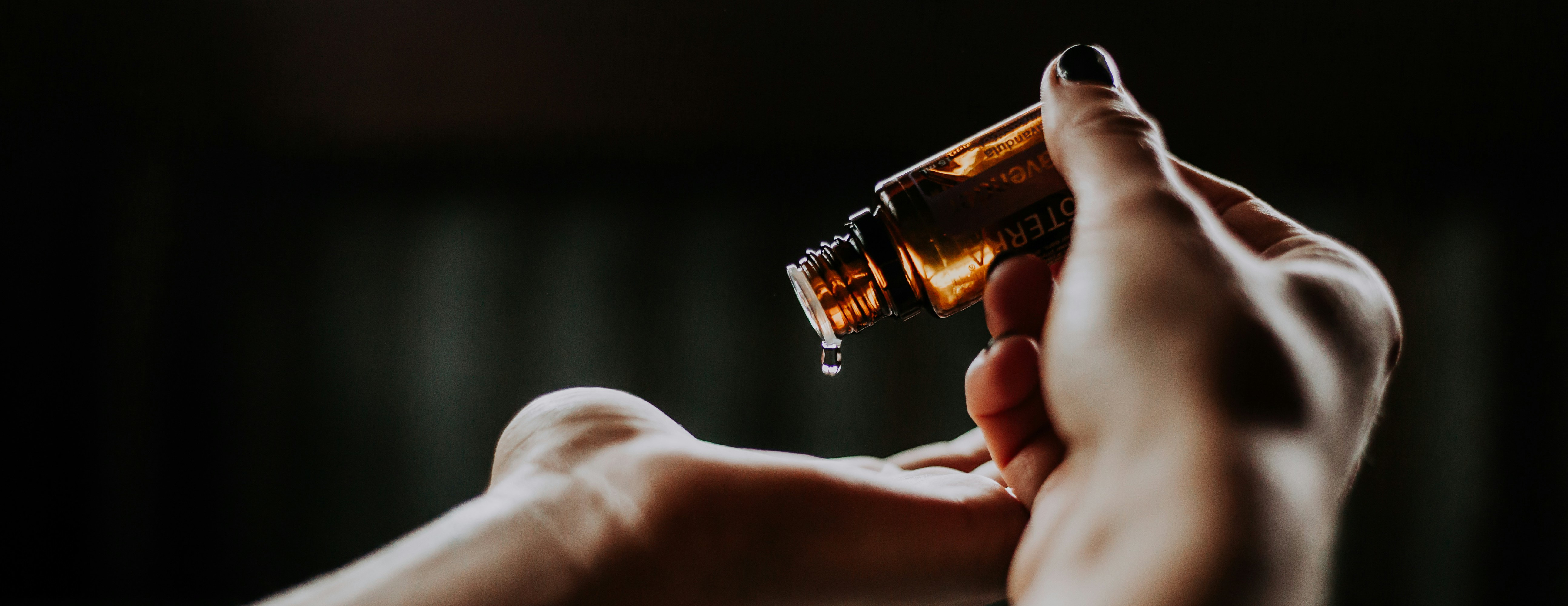 Person applying essential oil to their hand